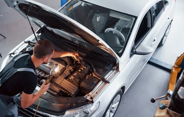 Mechanic Inspects Engine Bay